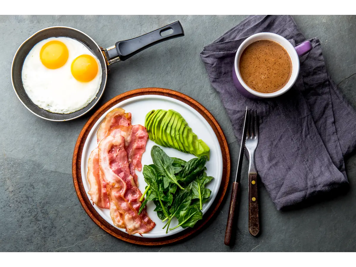 Talerze z jajkami, z boczkiem, szpinakiem i awokado. Obrazek w artykule 5 pomysłów na śniadanie keto, które Cię zaskoczą
